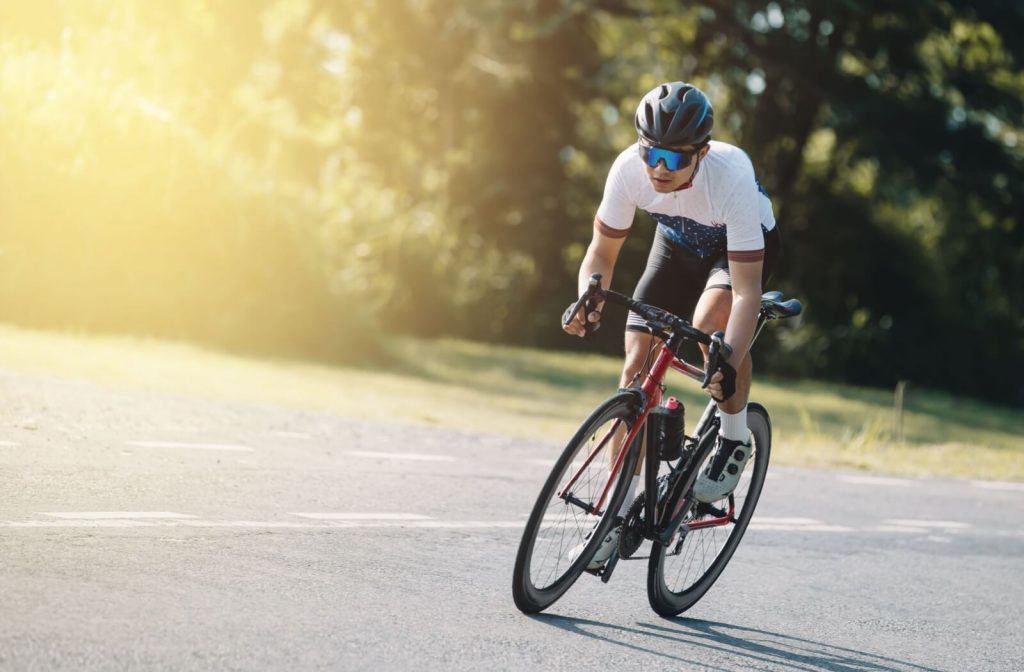A road cyclist wearing sunglasses.